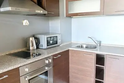 a kitchen with a microwave and a sink at APARTELLO⊛com DIAMOND - private apartments near Marina Dinevi in Sveti Vlas in Sveti Vlas