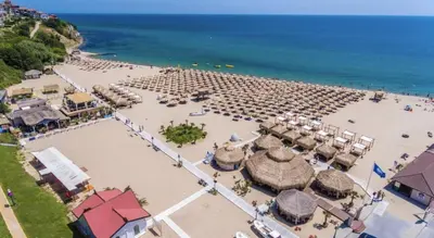 an aerial view of a beach with umbrellas and the ocean at APARTELLO⊛com DIAMOND - private apartments near Marina Dinevi in Sveti Vlas in Sveti Vlas