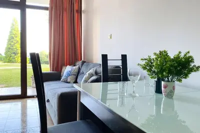 a living room with a table and a couch at APARTELLO⊛com DIAMOND - private apartments near Marina Dinevi in Sveti Vlas in Sveti Vlas
