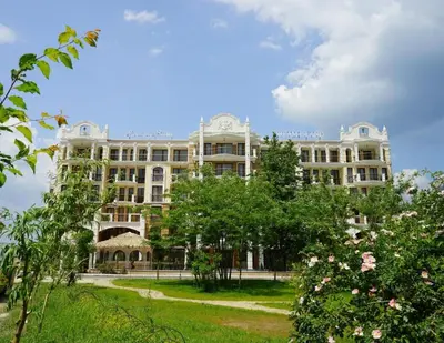 a large building with a park in front of it at Harmony Suitеs apartment in Sunny Beach