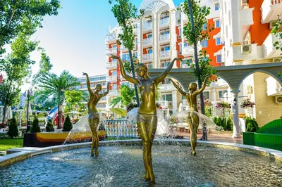 a statue of three girls in a fountain at Sunny studio in Sweet Home Complex in Sunny Beach