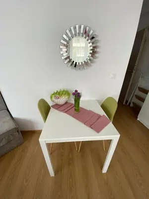 a white table with green chairs and a mirror at Sunny studio in Sweet Home Complex in Sunny Beach