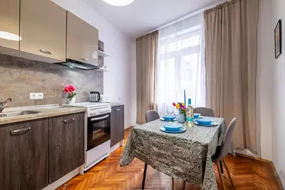 a kitchen with a table with blue plates on it at Lovely Art apartment - Victory in Varna City
