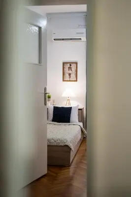 a bedroom with a bed through a door at Lovely Art apartment - Victory in Varna City