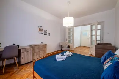 a bedroom with a blue bed with towels on it at Lovely Art apartment - Victory in Varna City