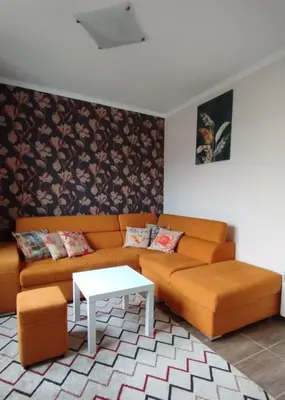 a living room with a couch and a table at Apartments SunWave Saint Vlas in Sveti Vlas