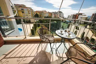 a balcony with a table and chairs on a balcony at Apartments SunWave Saint Vlas in Sveti Vlas