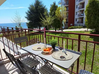 a table with a bowl of fruit on a balcony at Apartment in Sveti Vlas in Sveti Vlas