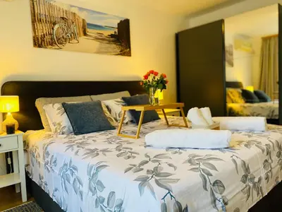 a bedroom with a large bed with a vase of flowers on it at Apartment in Sveti Vlas in Sveti Vlas