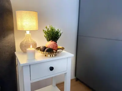 a table with a lamp and a bowl of fruit and a candle at Apartment in Sveti Vlas in Sveti Vlas
