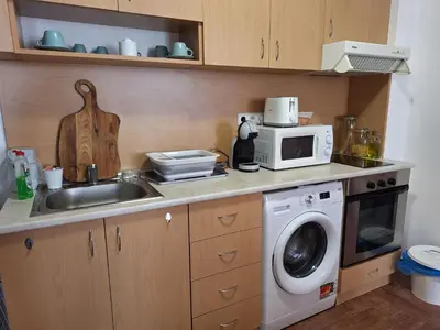 a kitchen with a sink and a washing machine at Apartment in Sveti Vlas in Sveti Vlas