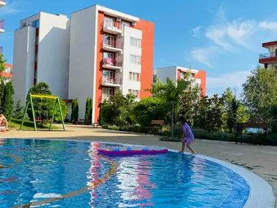 a young girl walking in a swimming pool at Apartment in Sveti Vlas in Sveti Vlas