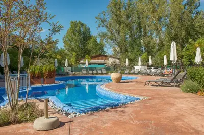 a swimming pool in a resort with umbrellas at Cascadas Holiday Apartments in Sunny Beach