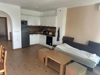 a room with a bed and a table and a kitchen at Fantastic Apartment in Sveti Vlas in Sveti Vlas