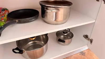 two pots and pans on a shelf in a kitchen at Fantastic Apartment in Sveti Vlas in Sveti Vlas