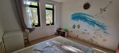 a bedroom with a painting of a wave on the wall at Two room apartment in Etara 3, Sveti Vlas in Sveti Vlas