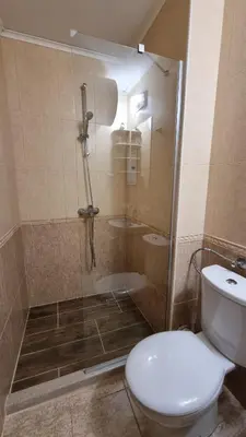 a bathroom with a toilet and a glass shower at Two room apartment in Etara 3, Sveti Vlas in Sveti Vlas