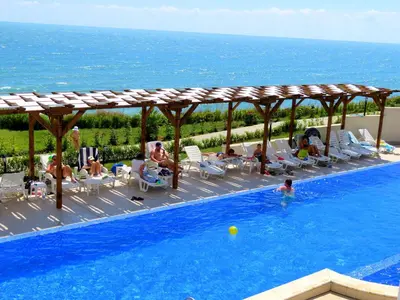 a group of people sitting in a swimming pool at Byala Cliff Sea View Suite in Byala