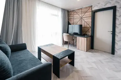 a living room with a couch and a table at хотел ADDRESS in Ravda