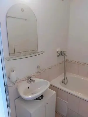 a bathroom with a sink and a mirror and a tub at Apartmány Rose Residence Nesebar in Sunny Beach