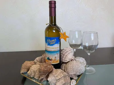 a bottle of wine and two wine glasses on a table at Apart hotel Gallery L in Sunny Beach