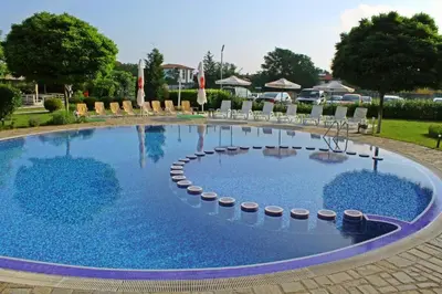 a large swimming pool with lounge chairs around it at Studio Fresh in Sozopol