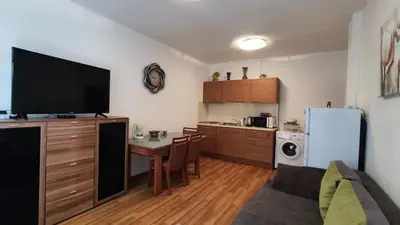 a small kitchen with a table and a refrigerator at Apartmán Katka, Obzor in Obzor
