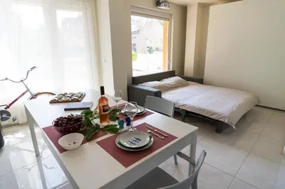 a living room with a table and a bed at Sea grape wine flat in old center in Varna City