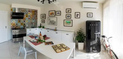 a kitchen with a white table and a black refrigerator at Sea grape wine flat in old center in Varna City