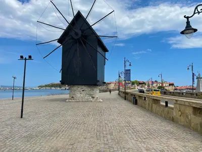 a large sculpture on a sidewalk next to the water at ROYAL BEACH & APARTAMENT in Sunny Beach