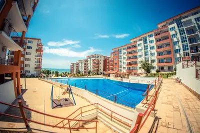 a swimming pool in the middle of a apartment complex at Beautiful apartment right by the sea, Sveti Vlas in Sveti Vlas