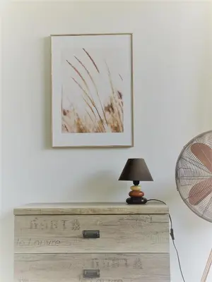 a lamp on top of a dresser next to a fan at Villa Rada, Bay View Villas in Kosharitsa