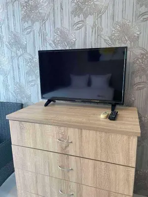 a flat screen tv sitting on top of a dresser at Apart hotel Gallery Studio in Sunny Beach