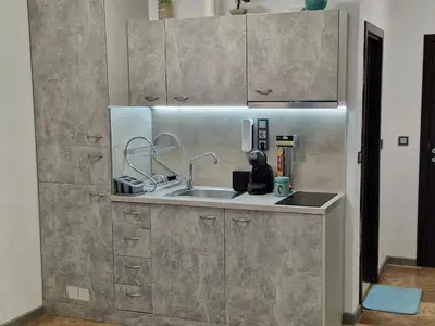a stainless steel kitchen with a sink and cabinets at Апарткомплекс Амара Слънчев Бряг Студио 13 in Sunny Beach
