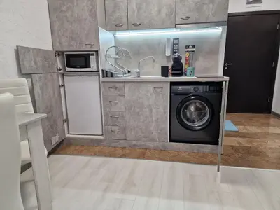 a kitchen with a washing machine and a sink at Апарткомплекс Амара Слънчев Бряг Студио 13 in Sunny Beach