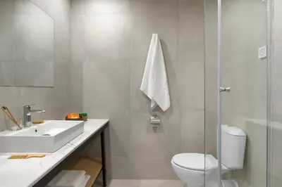 a bathroom with a white sink and a toilet at PERLA TUI SUNEO All inclusive in Sunny Beach