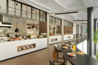 a large kitchen with a table and chairs in a restaurant at PERLA TUI SUNEO All inclusive in Sunny Beach