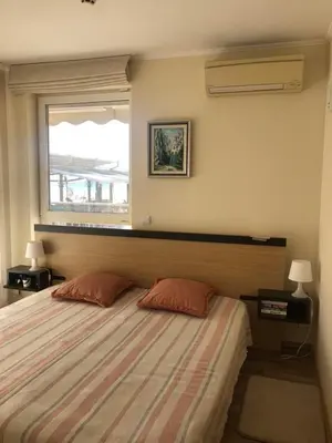 a bedroom with a bed with two pillows and a window at Obzor Beach Resort Beachfront in Obzor