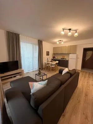 a living room with a couch and a kitchen at Studio Marrone on Bogoridi in Burgas City
