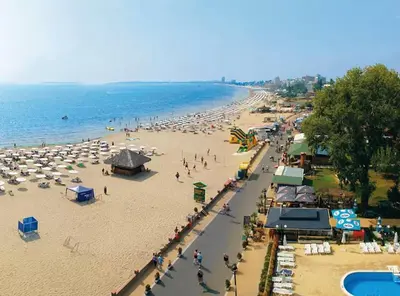 a beach with a lot of umbrellas and people on it at SUMMER BREEZE 110 Cozi Studio in Sunny Beach