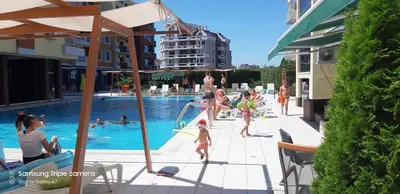 a group of people standing around a swimming pool at Studio Milenium in Pomorie