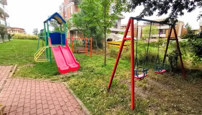 a park with a playground with a swing set at Апартамент СаMи in Burgas City