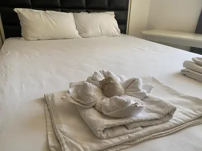a white towel sitting on top of a bed at Penthouse Happy Moments 2 in Sunny Beach