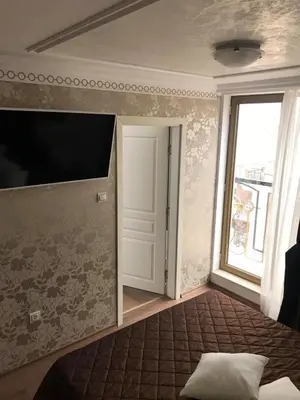 a room with a tv and a door and a window at Penthouse Happy Moments 2 in Sunny Beach