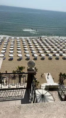 a beach with a bunch of umbrellas and the ocean at Penthouse Happy Moments 2 in Sunny Beach