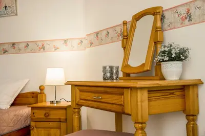 a dressing table with a mirror and a bed at Panorama Chantall-izby,apartmány s výhľadom na more in Ravda