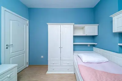 a room with a bed and a blue wall at Varna Central Ohrid 2bdr Apartment in Varna City