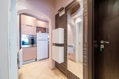 a kitchen with a white refrigerator and a door at Varna Central Ohrid 2bdr Apartment in Varna City