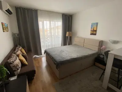 a small bedroom with a bed and a window at Royal Palm Studio with Seaview in Sveti Vlas