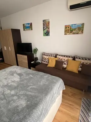 a living room with a bed and a couch at Royal Palm Studio with Seaview in Sveti Vlas